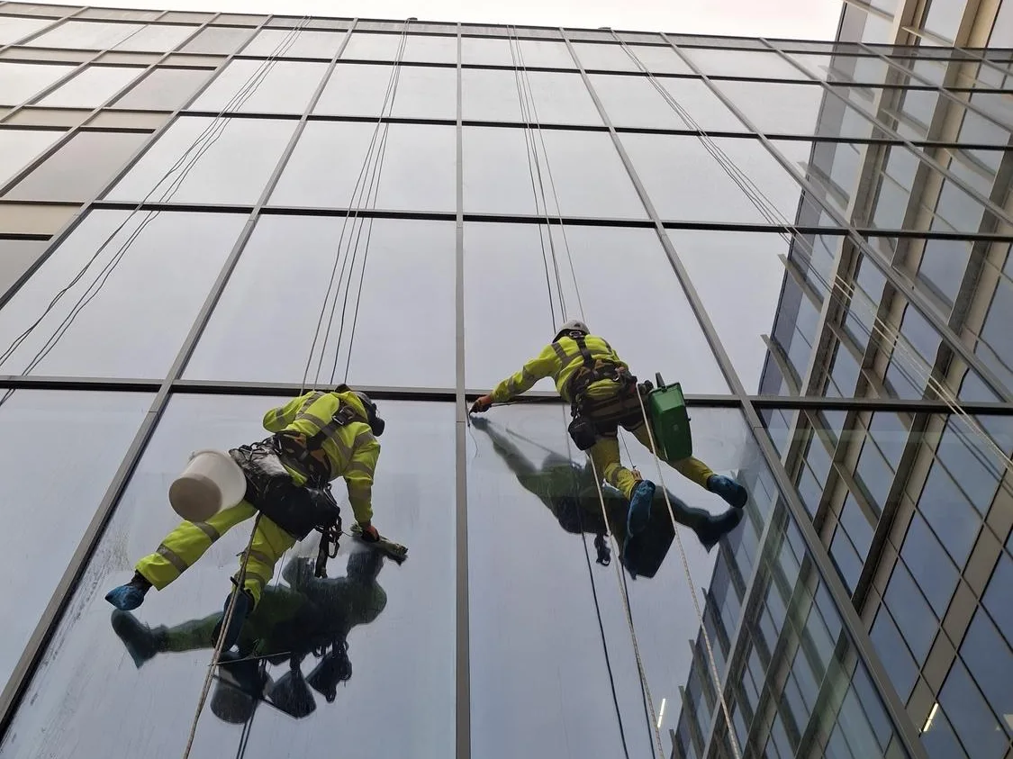 Rope access technicians cleaning glazing at Pilgrims Quarter Newcastle