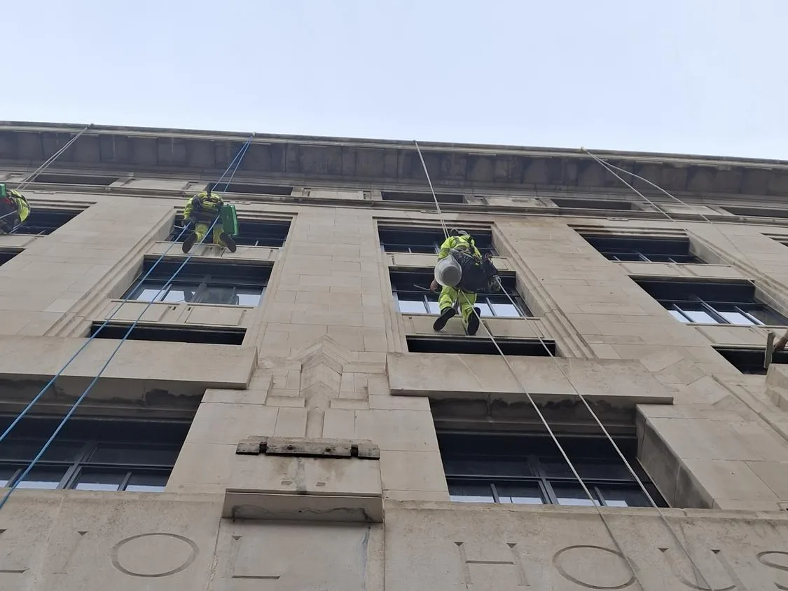 Cleaning the retained historic facade at Pilgrims Quarter on ropes